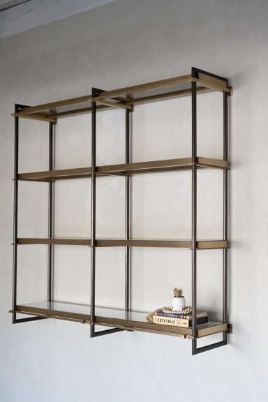 The Milano Series Milano Series wall-mounted shelving crafted from custom bronze extrusions with integrated lighting.